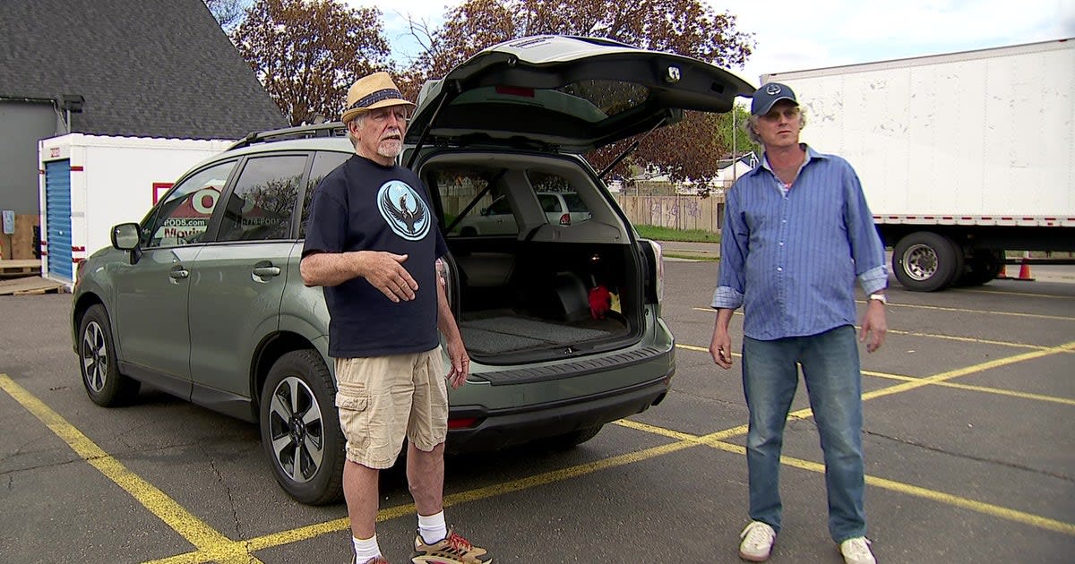 Tow truck with car hooked up delivering groceries to Minneapolis families in need