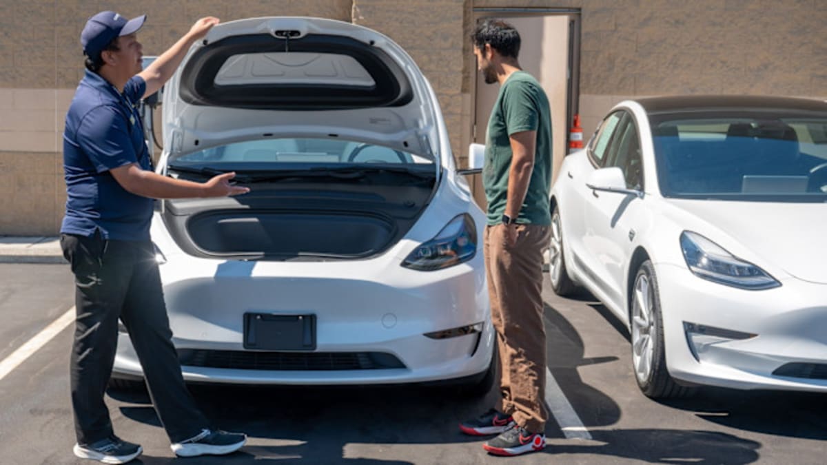 Row of affordable used electric vehicles parked at dealership lot ready for buyers