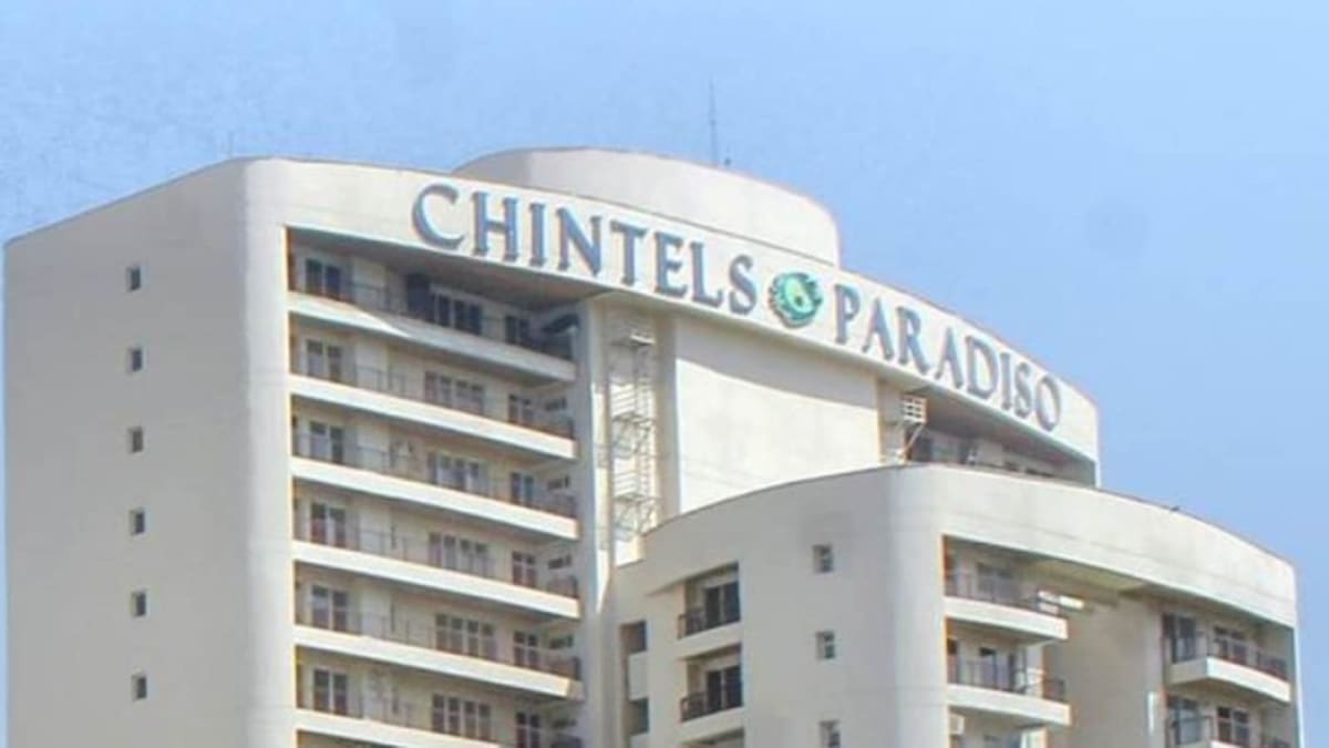 Multi-story residential apartment building complex in urban Indian neighborhood setting