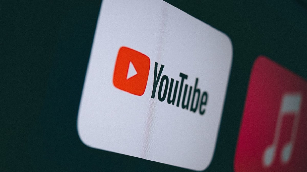 YouTube logo on smartphone screen with facial recognition scanning interface overlay