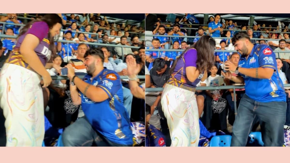 ** Cricket fan proposing to girlfriend in crowded stadium seats during IPL match at Wankhede Stadium