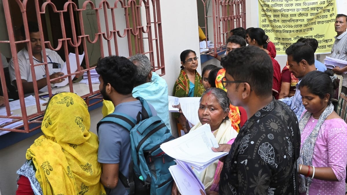 ** Smiling Indian citizens holding voter ID cards outside Gujarat High Court building