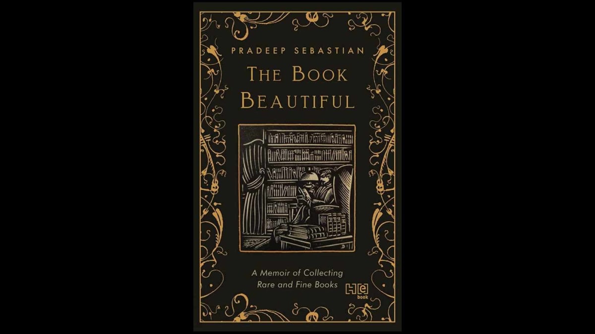 Pradeep Sebastian holding vintage book with ornate cover in Bengaluru bookshop surrounded by antique volumes