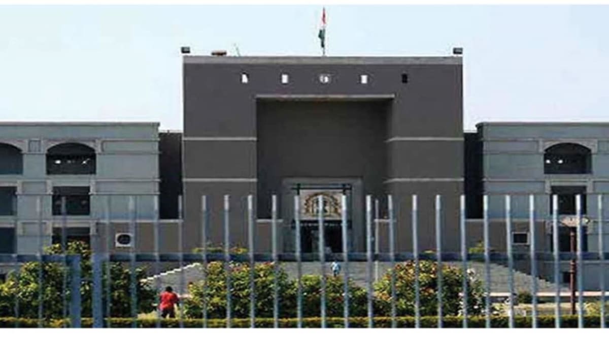 Gujarat High Court building exterior with Indian flag, representing judicial protection of voting rights