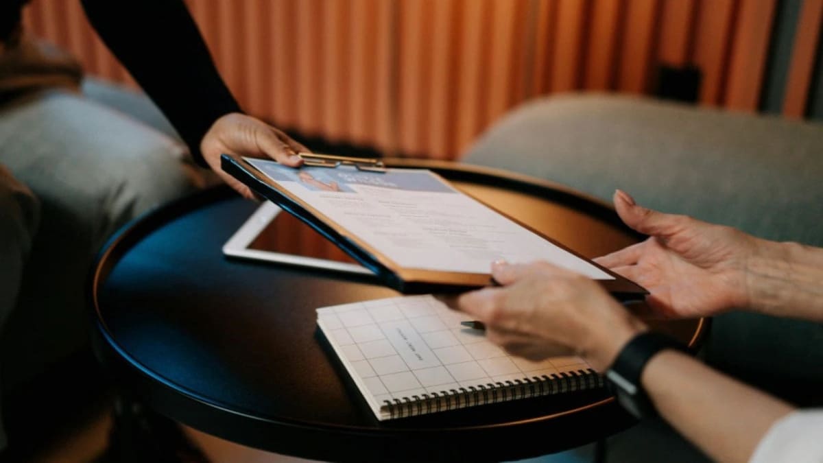 ** Indian students in classroom raising hands enthusiastically during lesson, representing educational opportunity