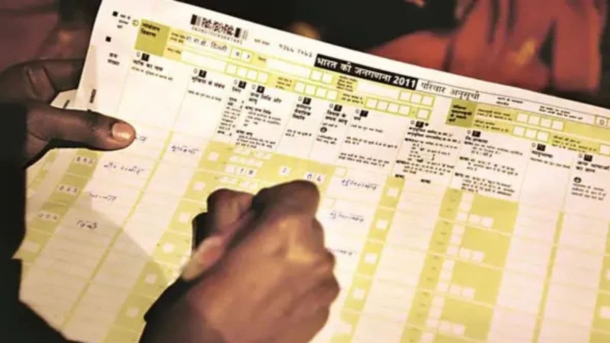 Government official reviewing updated census forms with respectful inclusive language in Punjab office