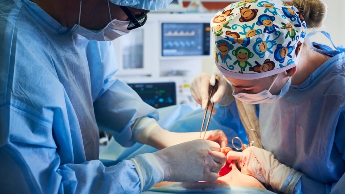 ** Neurosurgeon performing delicate brain surgery on patient in modern operating room