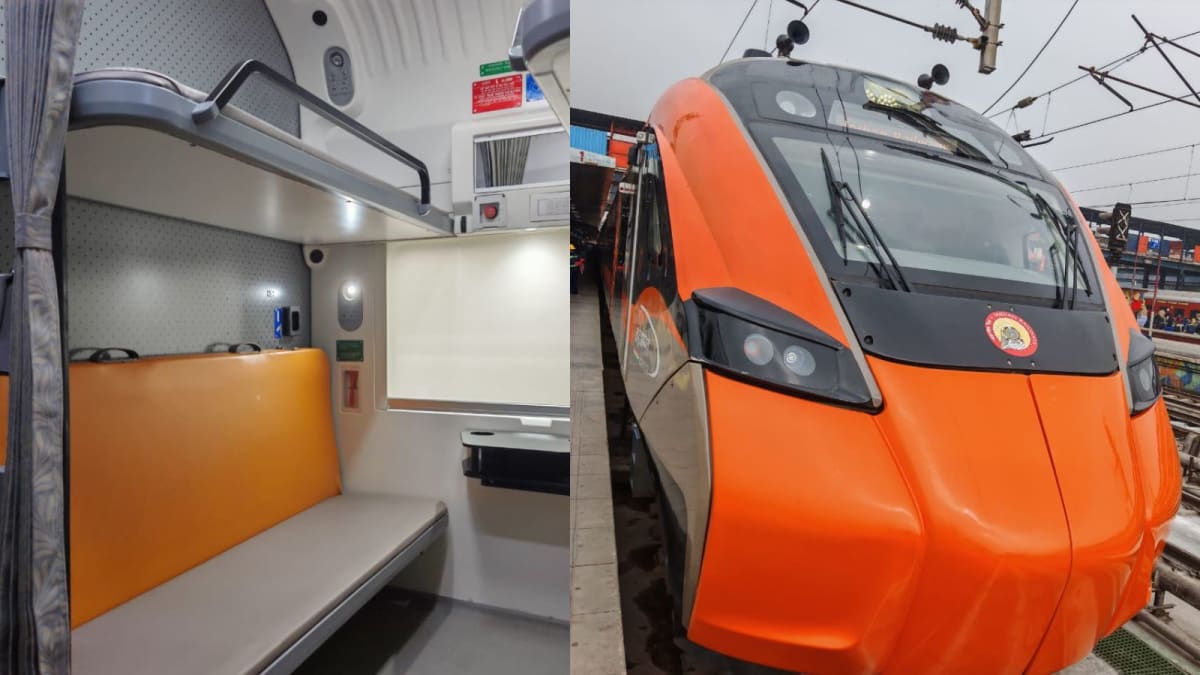 ** Orange and grey Vande Bharat sleeper train at railway platform in India