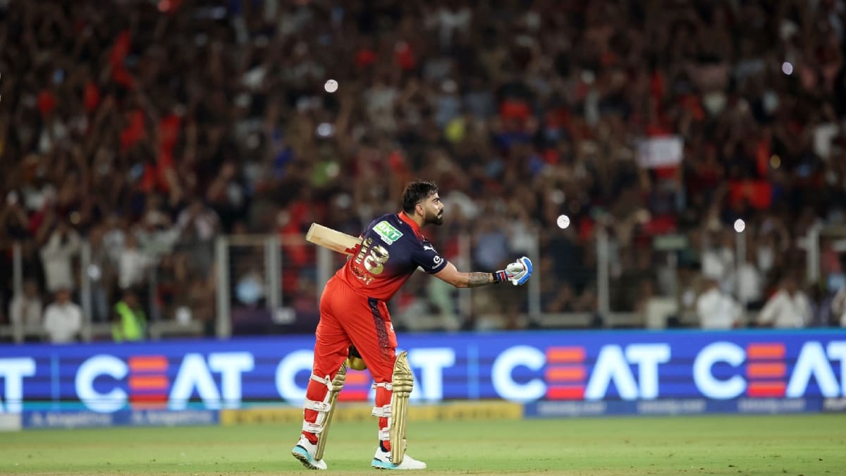 ** Virat Kohli celebrates with arms raised after winning IPL championship for RCB