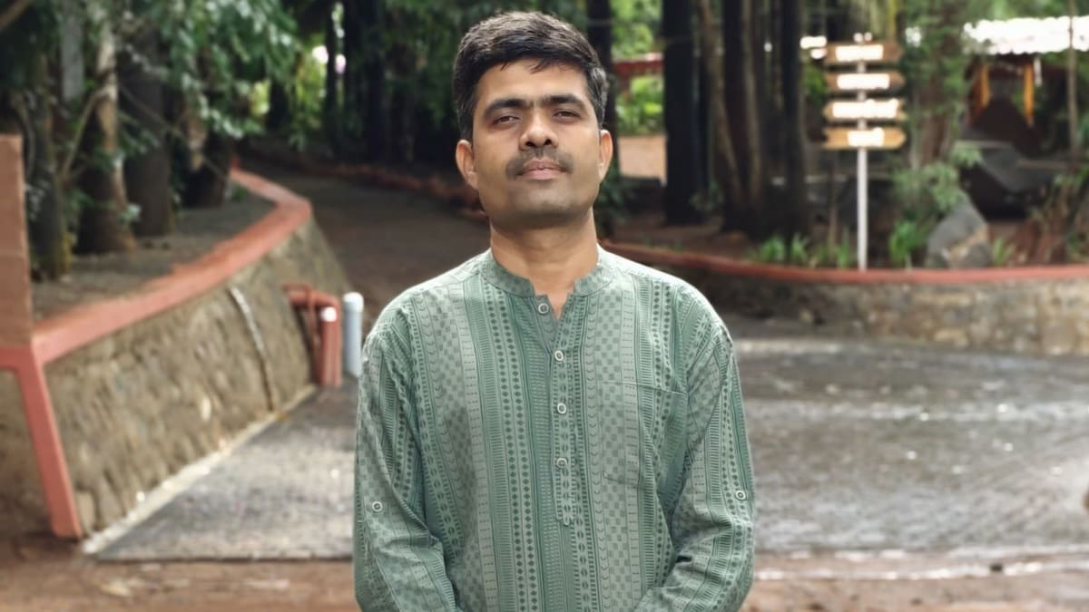 ** Rahul Jagtap standing at Anjanvel Agritourism location with green landscape and trees behind him