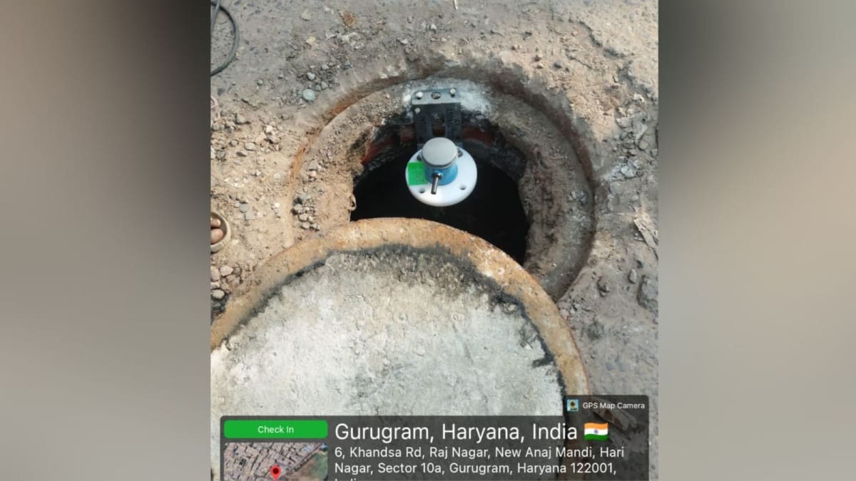 Sewer overflow sensor mounted on street infrastructure in Gurgaon, India to monitor water levels