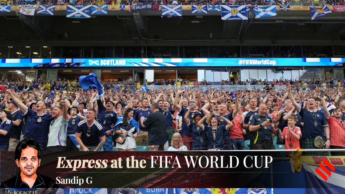 Scottish soccer fans in traditional kilts march through Boston streets waving flags
