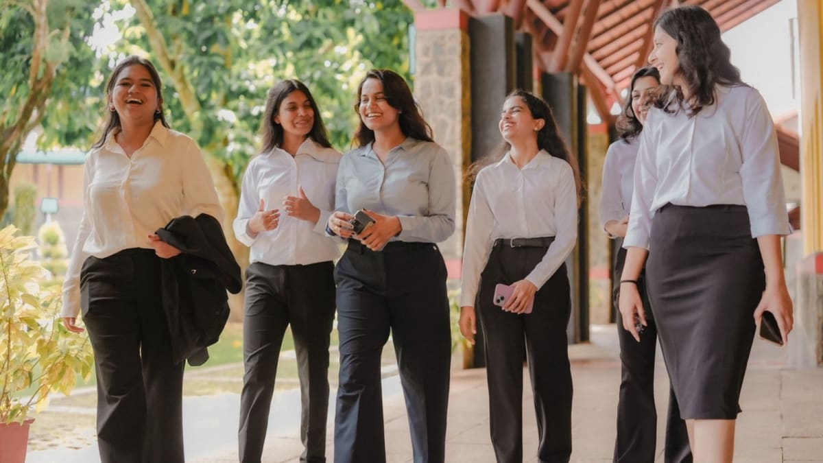 ** Diverse group of MBA students at IIM Kozhikode campus during orientation ceremony