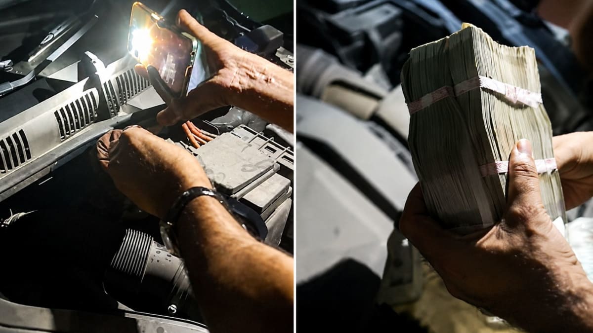 Police officer examining cash bundle found hidden under car hood during investigation