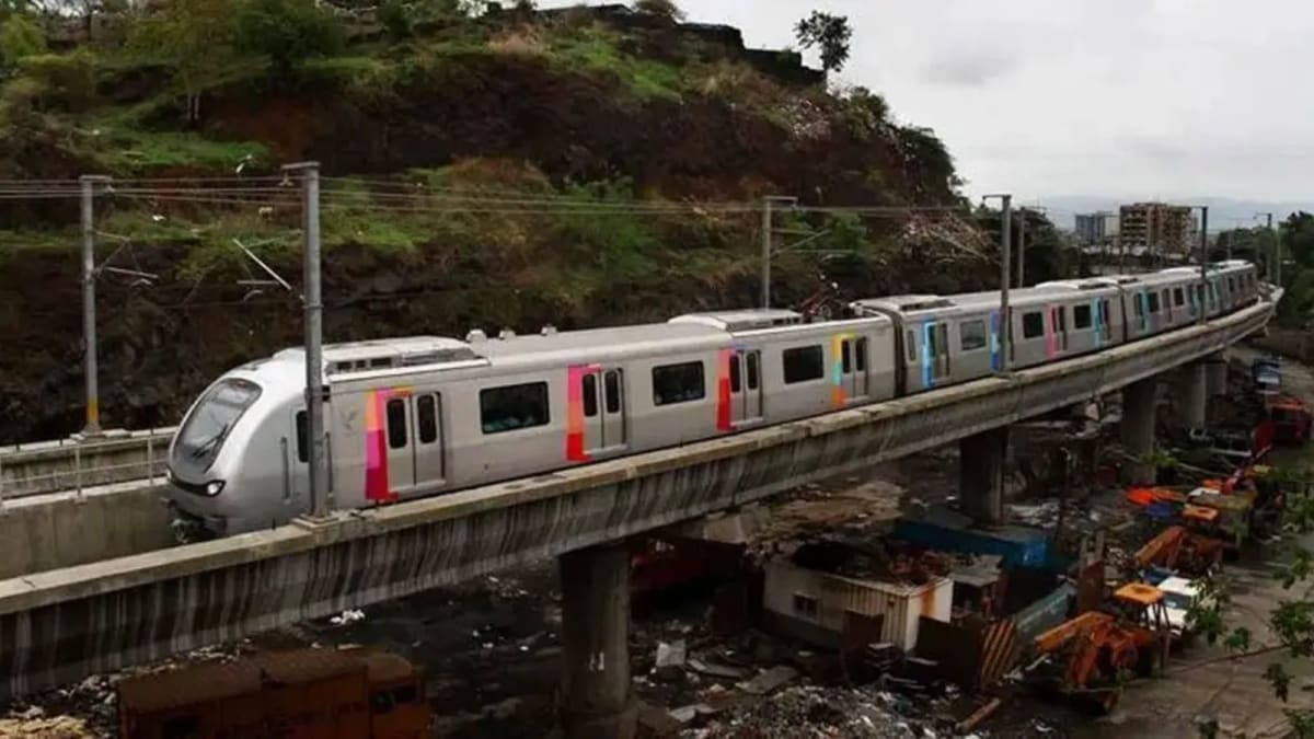 ** Mumbai Metro One train on elevated tracks carrying commuters along Versova-Ghatkopar corridor