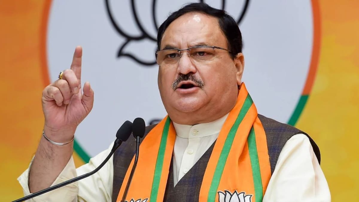 ** Indian political leaders J P Nadda and Mallikarjun Kharge walking together in Parliament hallway