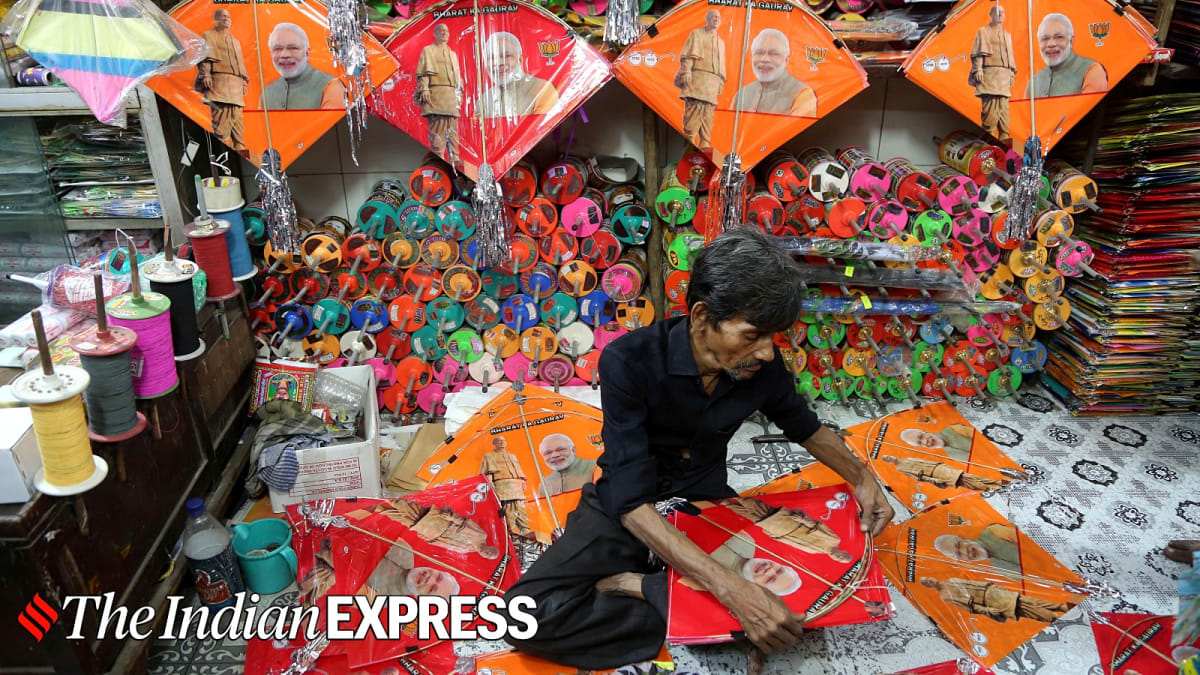 Indian artisan's hands carefully assembling colorful traditional kites in Delhi workshop