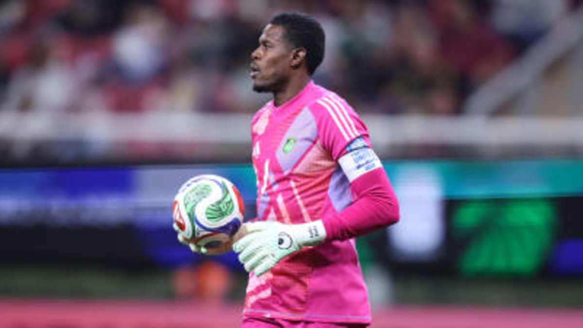 Andre Blake in Jamaica's yellow jersey making a save during World Cup qualifying match
