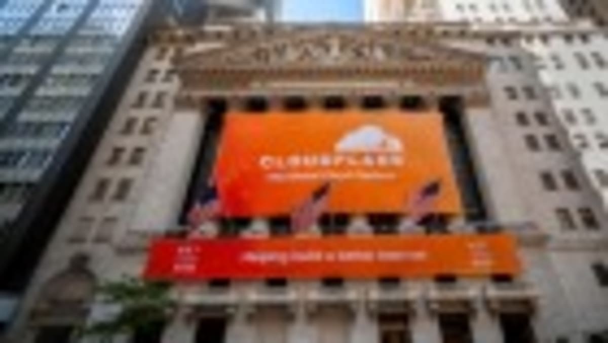 Librarian collaborating with scientists at research table, reviewing documents together in modern library setting