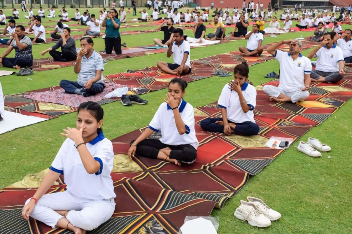 Person taking calm deep breath outdoors with peaceful expression demonstrating breathing technique