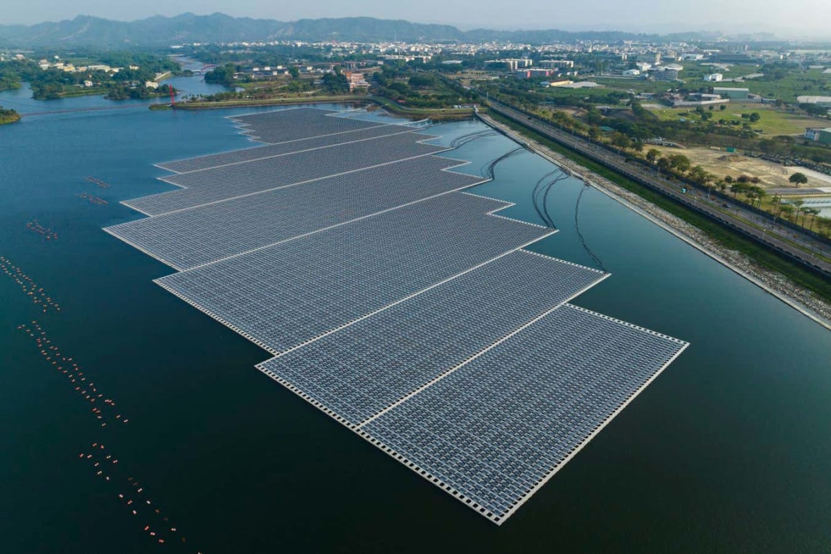 Aerial view of blue solar panels floating on ocean water in industrial bay Taiwan