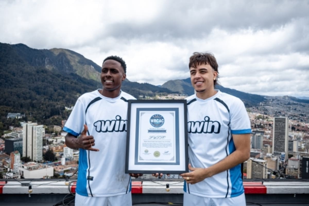 Football players competing on helipad atop Torre Colpatria building high above Bogotá cityscape