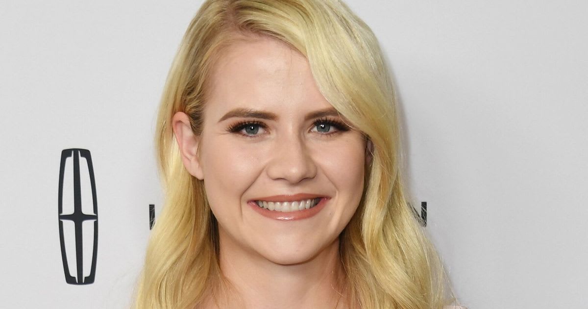 Elizabeth Smart smiling onstage in bodybuilding competition attire at Wasatch Warrior event