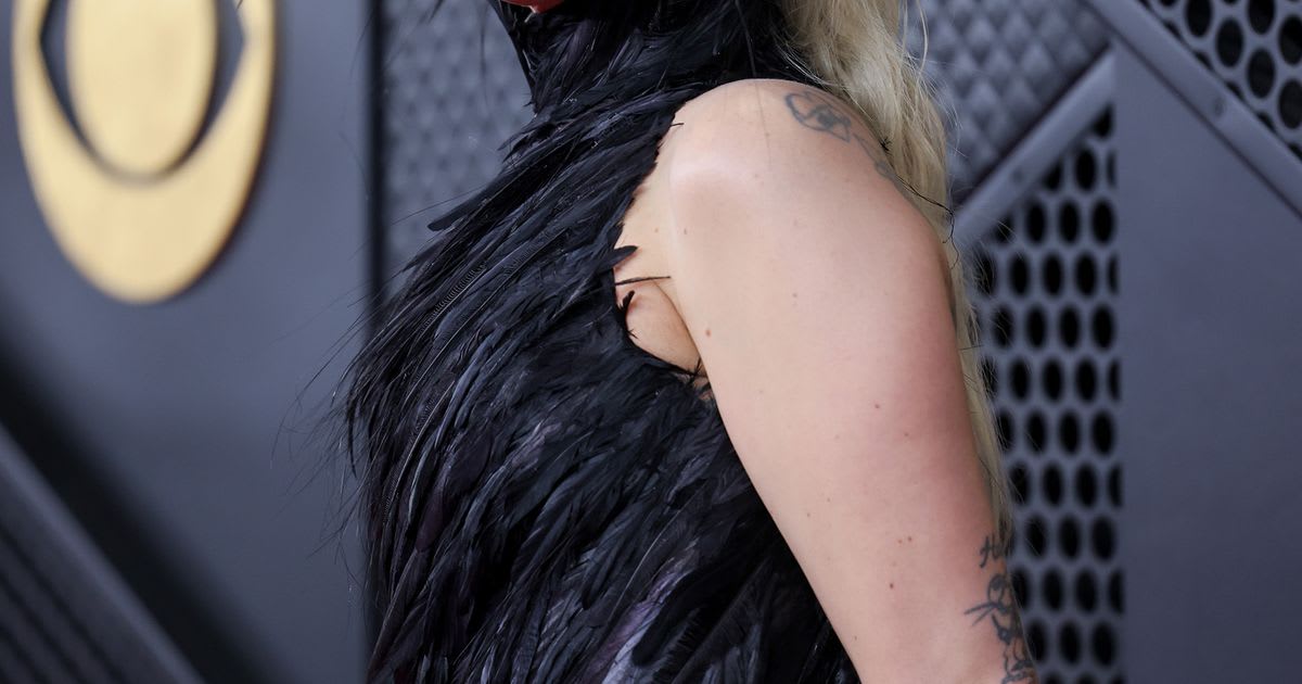 Lady Gaga in elegant gown on red carpet at Grammy Awards ceremony