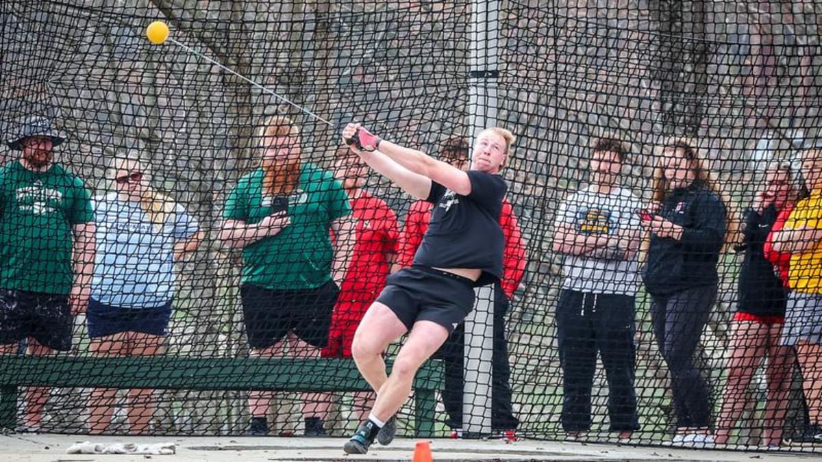 College athlete Zach Gose competing in hammer throw event at outdoor track meet
