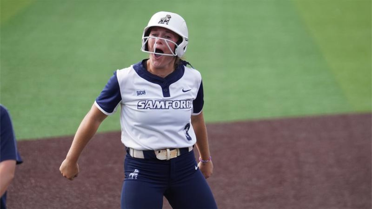 Samford softball players celebrating on field after comeback victory over Chattanooga
