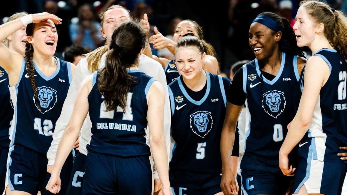 Columbia University women's basketball players celebrating on court after semifinal victory