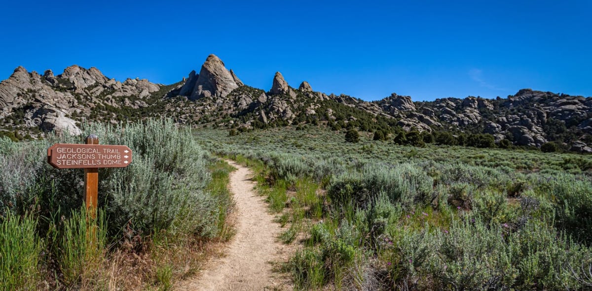 Hiker purifying water at campsite with mountain wilderness background during outdoor adventure