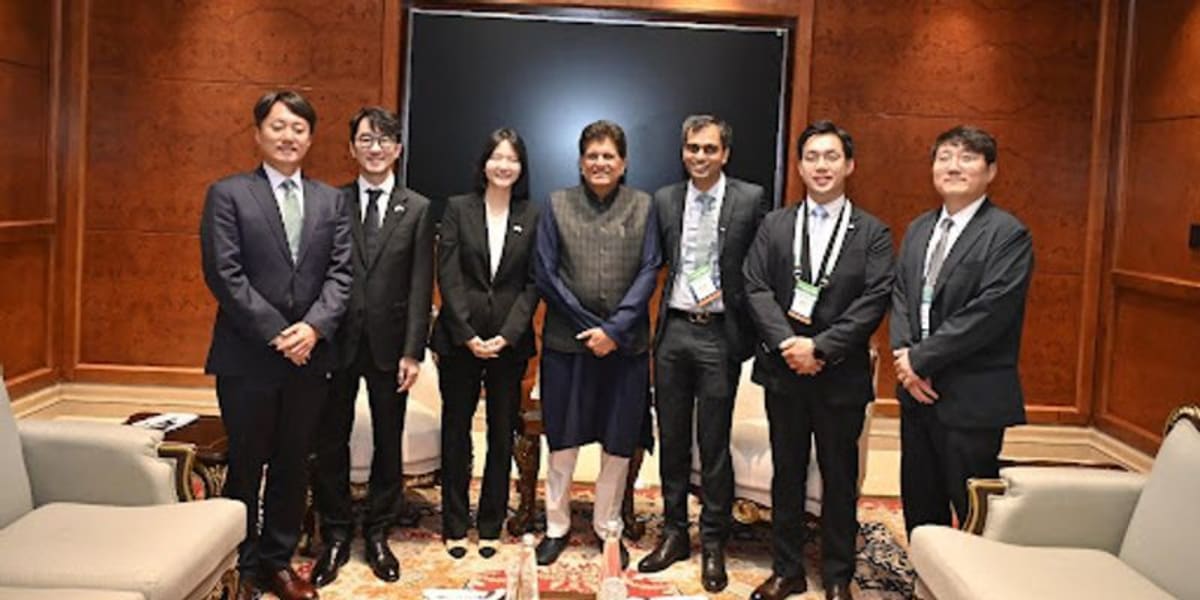 Business leaders shaking hands at India-South Korea tech investment partnership announcement ceremony