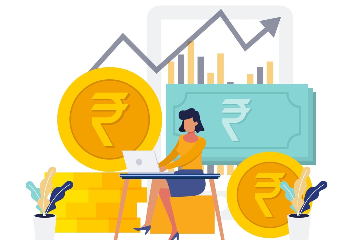 Indian woman reviewing financial documents on laptop, planning long-term investment strategy with confidence