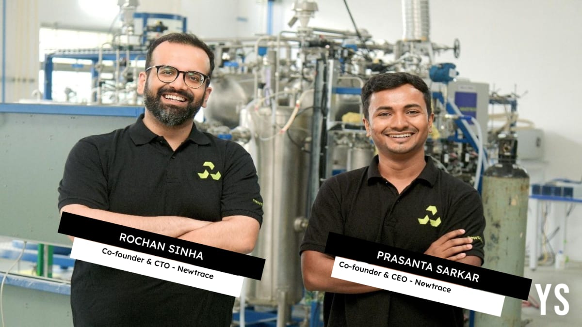 Scientists working on green hydrogen electrolyzer technology in modern laboratory setting