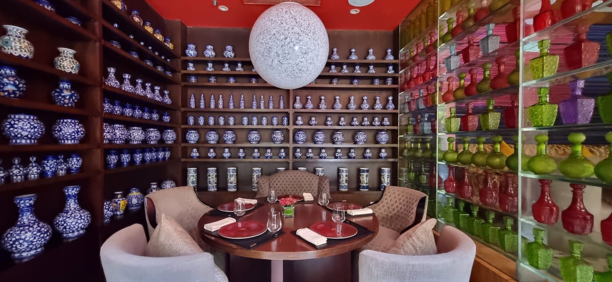 Elegant hotel lobby displaying colorful contemporary artworks and traditional Indian architectural elements