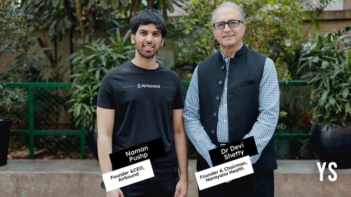 Lightweight medical delivery drone taking off vertically near modern hospital building in Bengaluru India