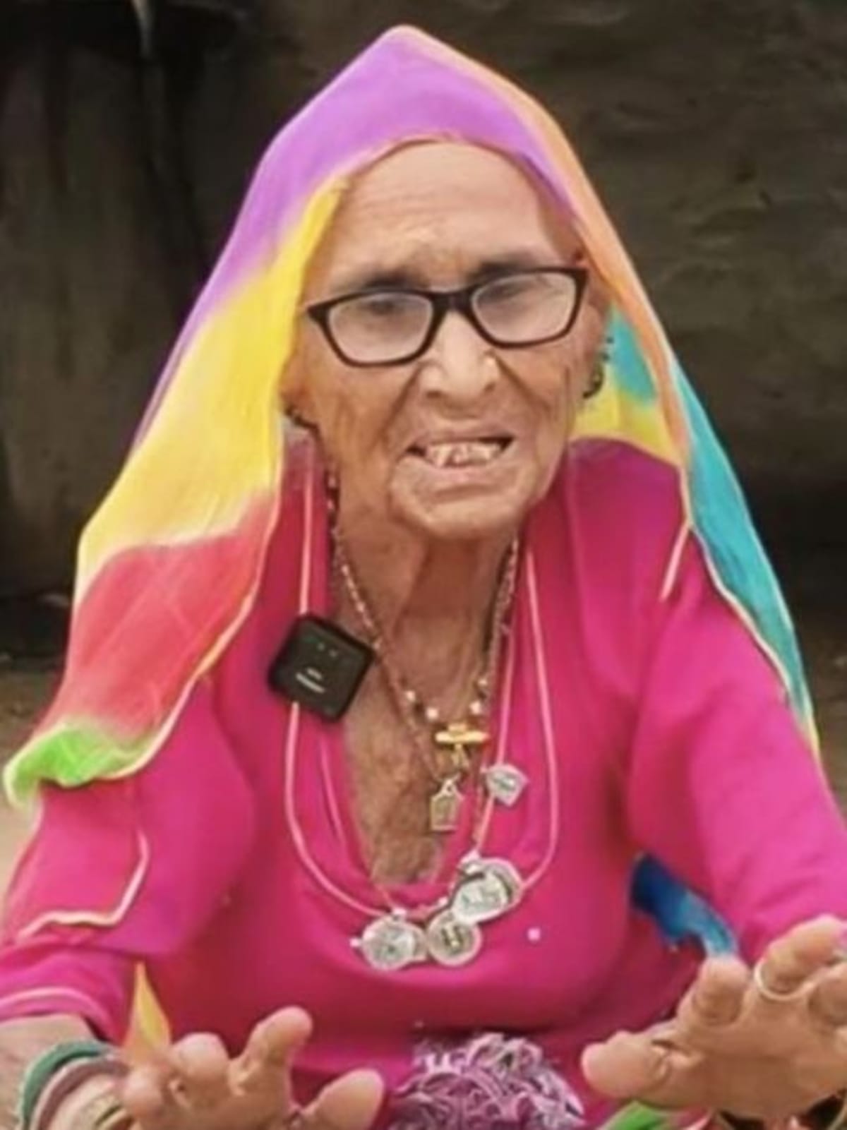 Elderly Indian midwife Suwa Dai Maa in traditional Rajasthani dress smiling warmly