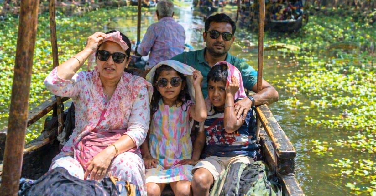 Happy Indian family with children exploring outdoor destination during summer vacation together