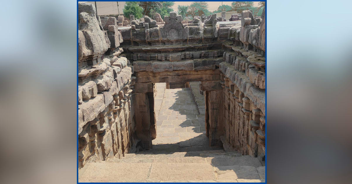 Ancient sandstone stepwell with serpent carvings leads down into restored 11th-century Karnataka water structure