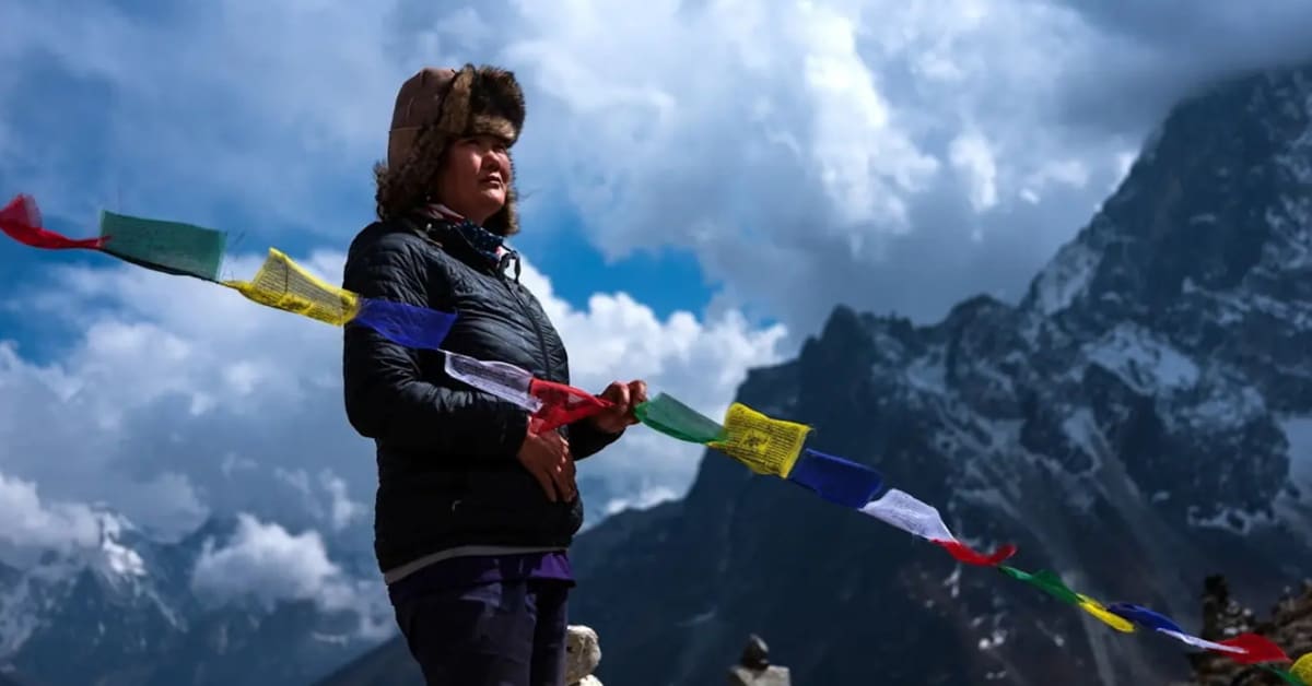 Lhakpa Sherpa in climbing gear standing near Mount Everest base camp