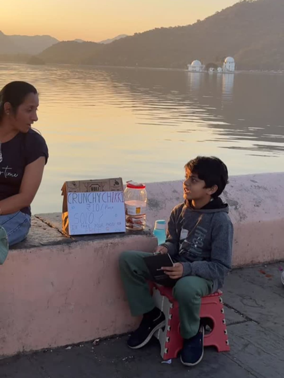 Indian child counting money at small roadside food stall learning business skills