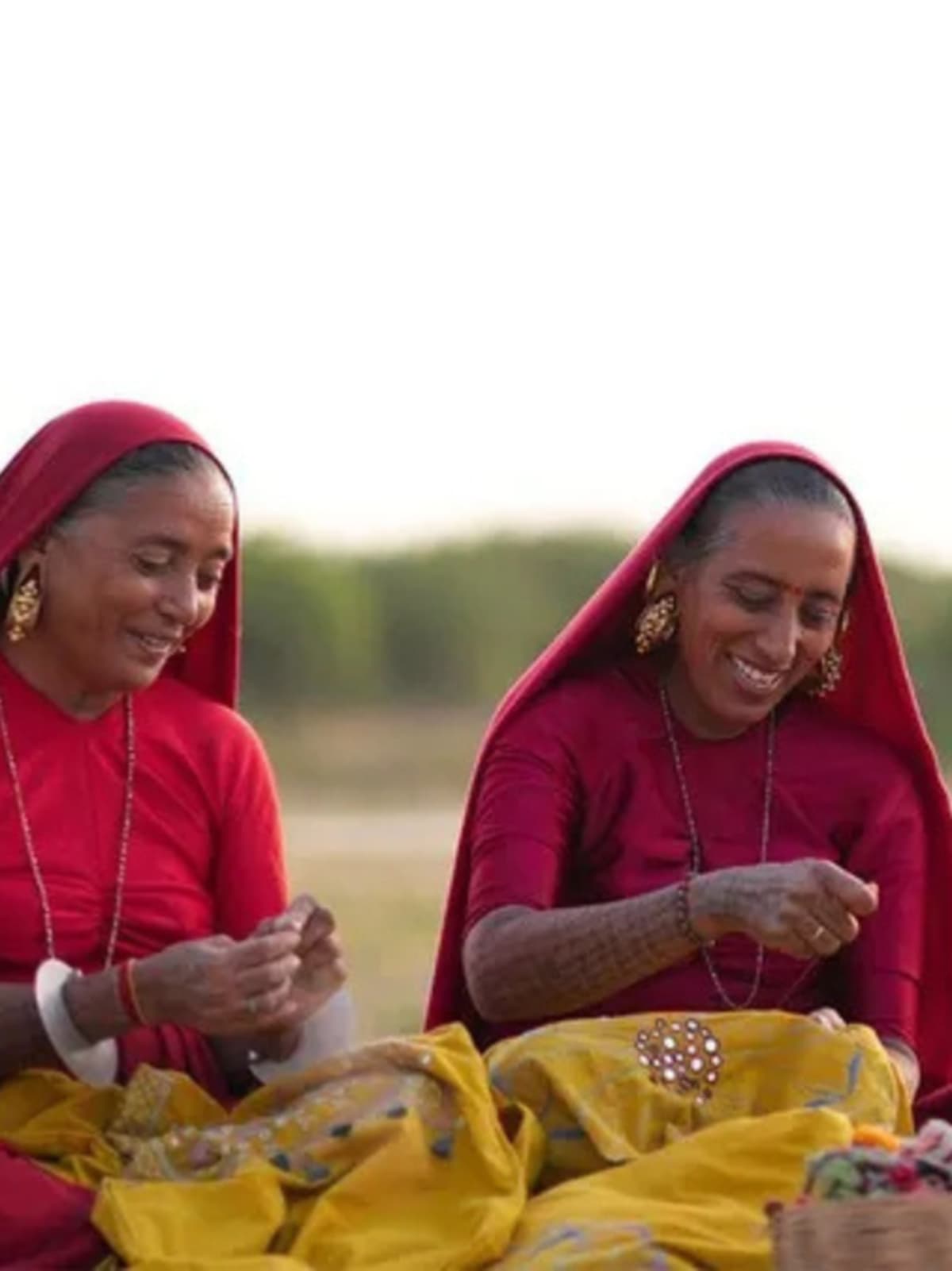Indian artisan working on colorful handwoven textile using traditional loom techniques