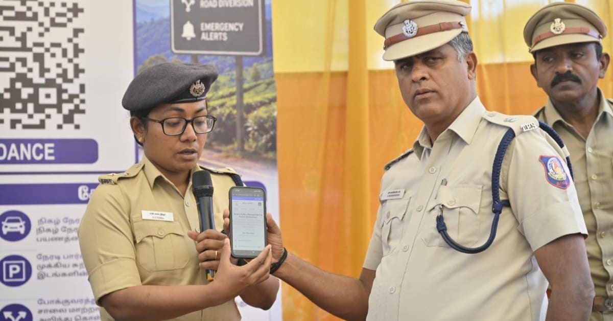 Tourist scanning QR code poster to access Puri Police WhatsApp chatbot service in India