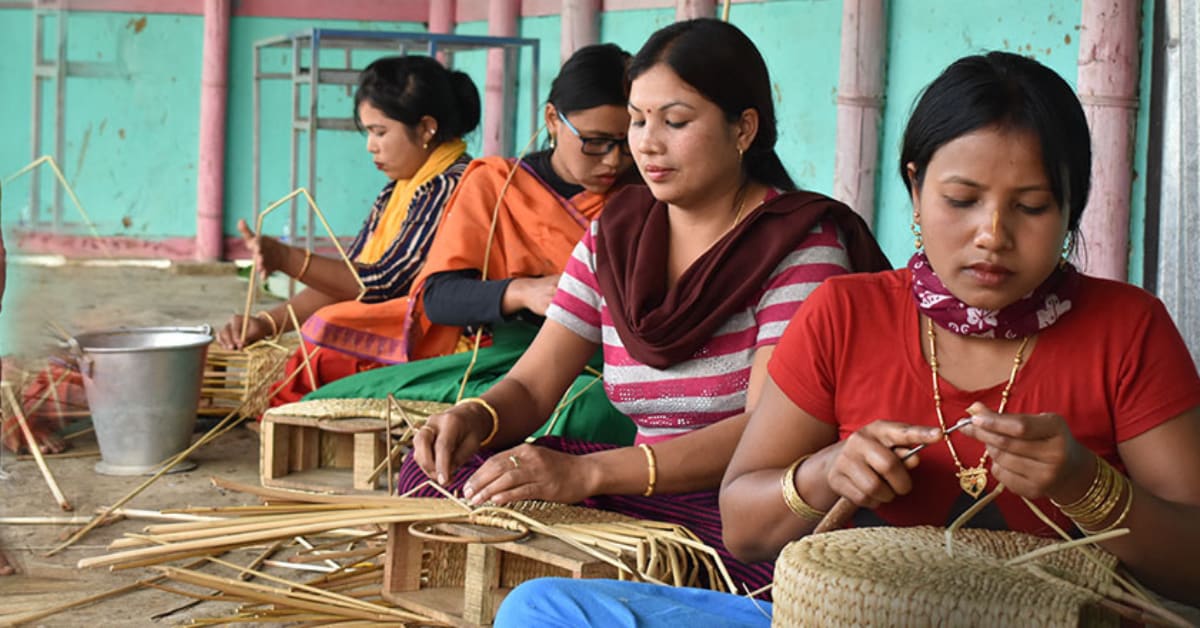 Young women artisans in Mizoram working together on traditional handwoven textiles and bamboo crafts