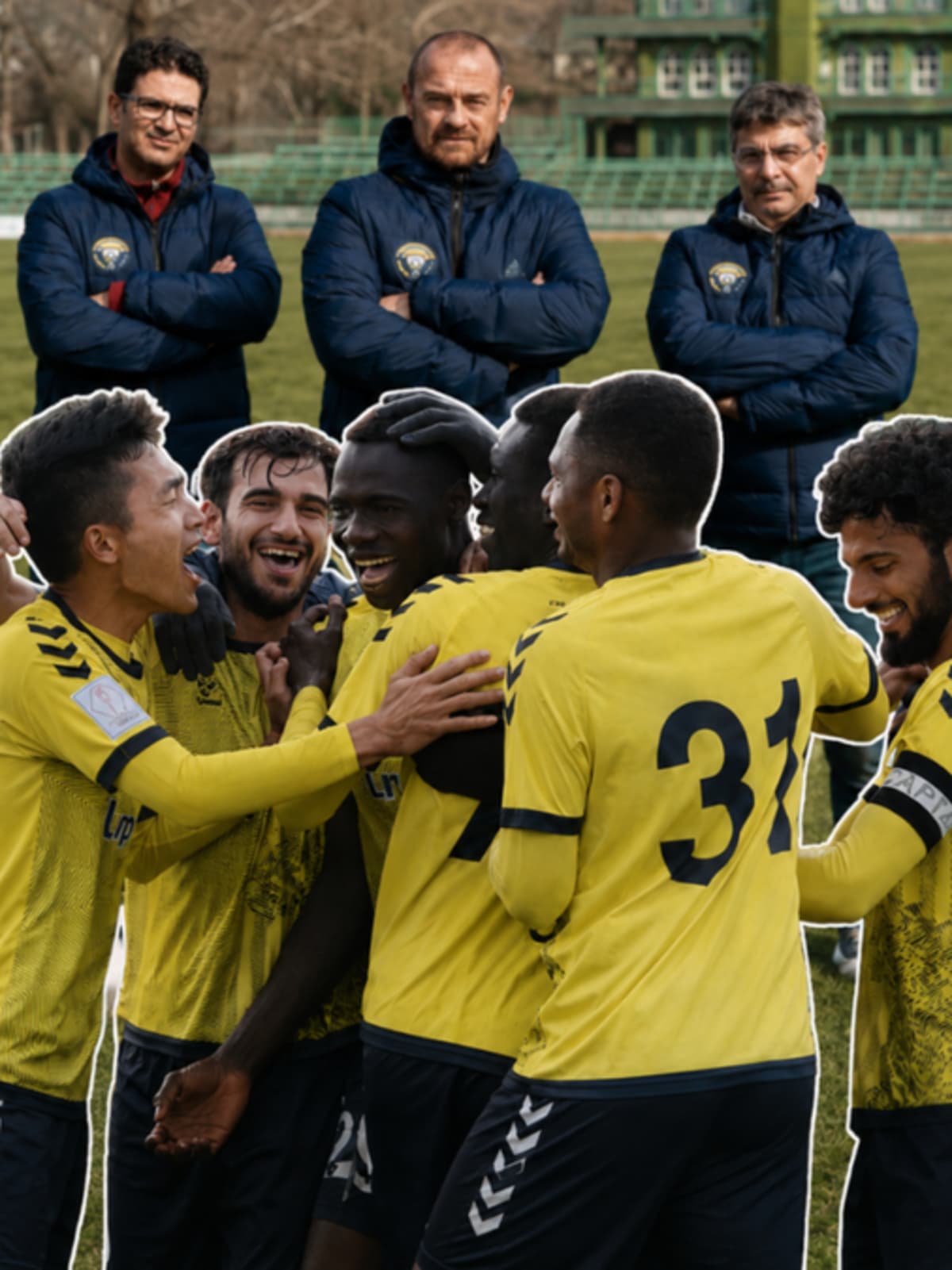 Real Kashmir FC football players celebrating on field in snowy mountain valley setting