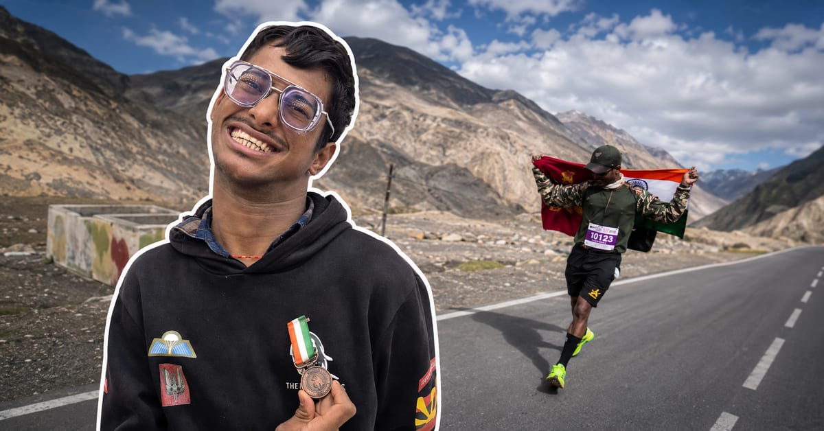 Young Indian man celebrating after completing mountain race in Himalayan valley