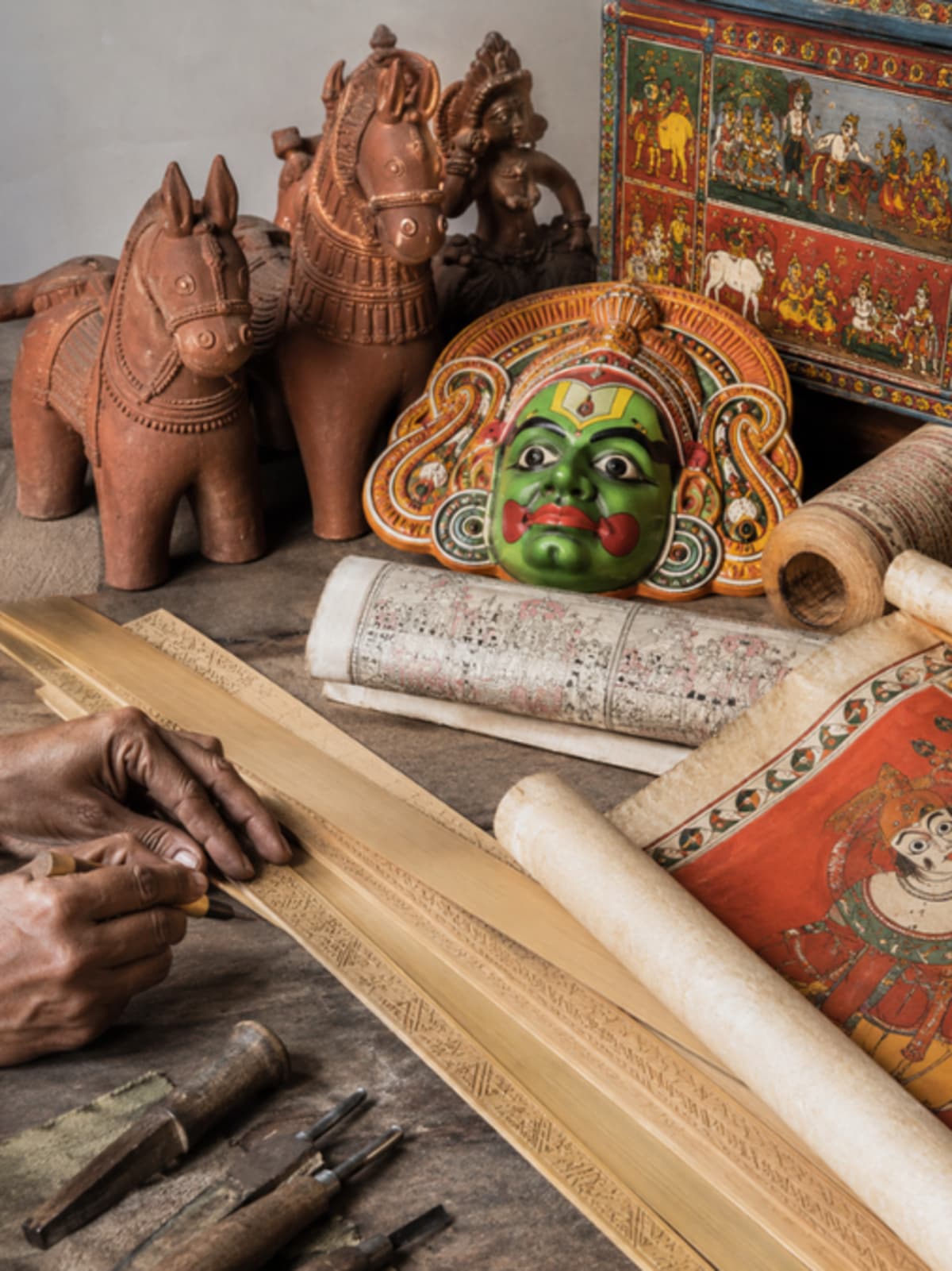 Colorful Indian folk art scroll painting showing traditional narrative scenes in bold natural pigments