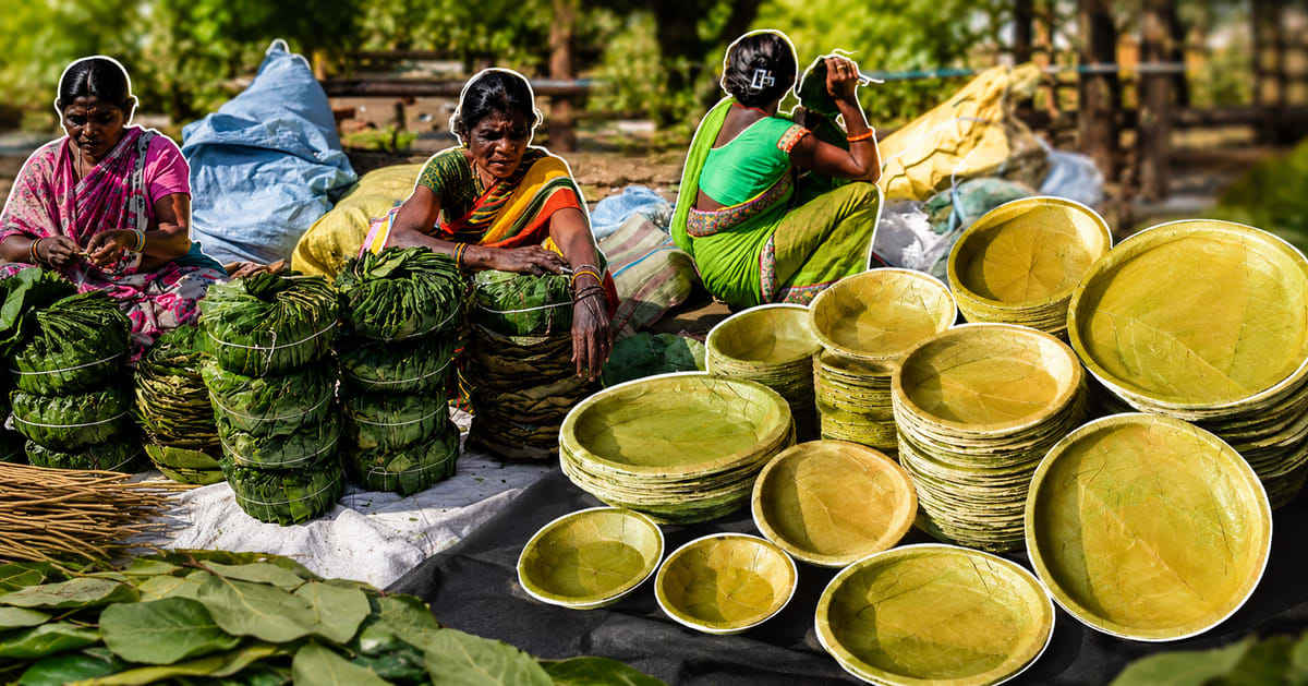 Handstitched plates made from natural sal leaves arranged on wooden surface showing traditional Indian craftsmanship