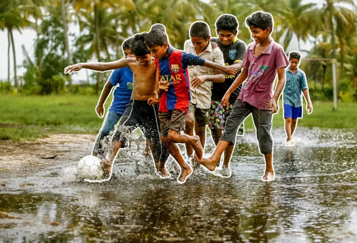 Young child walking through flooded street during Mumbai monsoon season with dirty rainwater